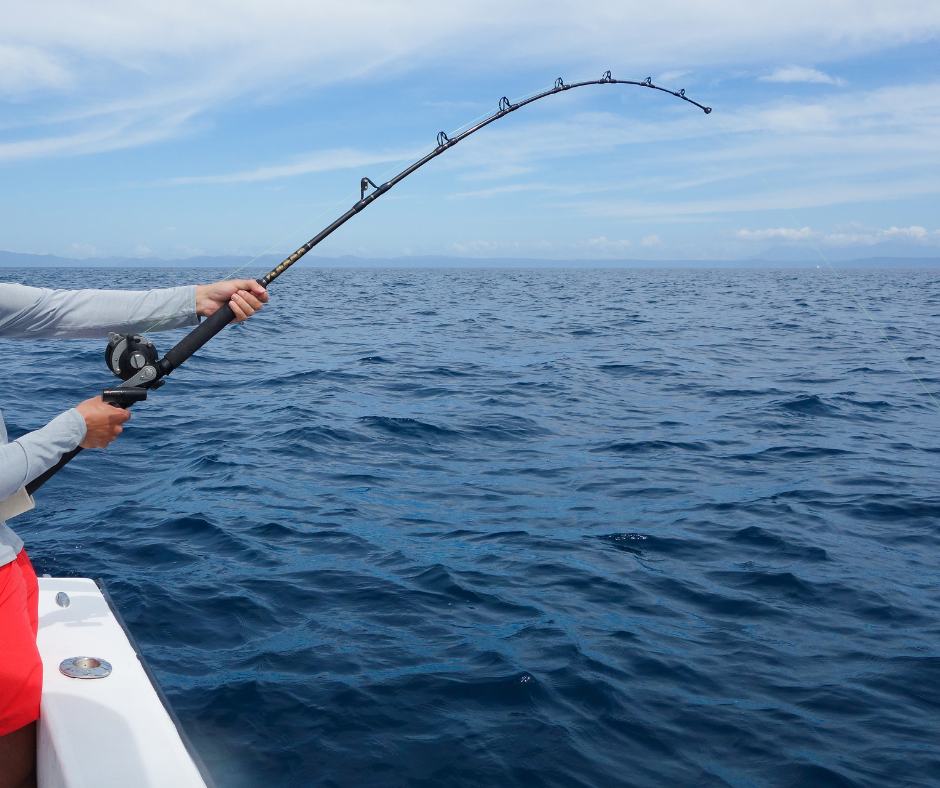 Angler with a bent rod on a Manuel Antonio sport fishing charter