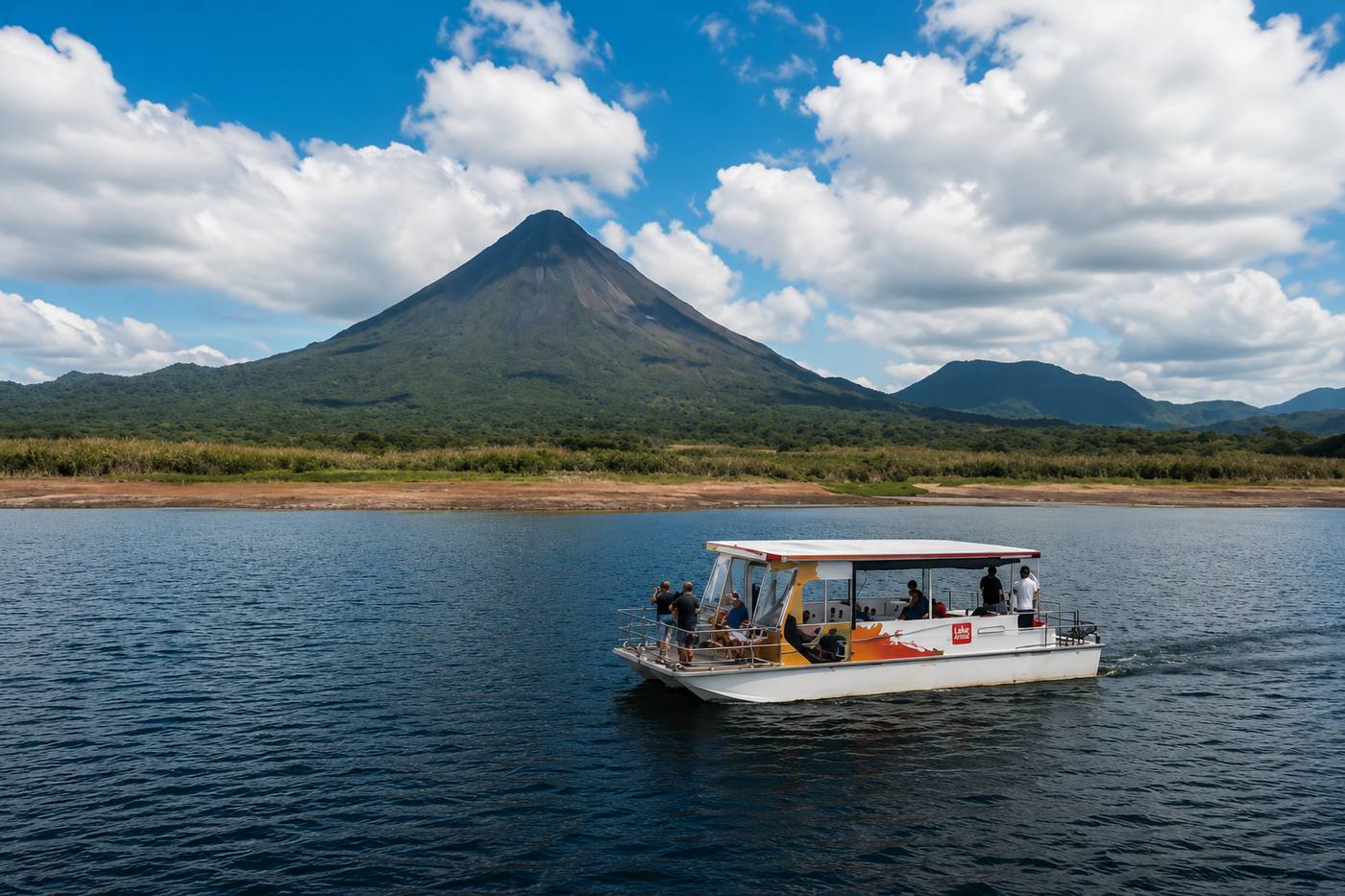 Boat tour crossing Lake Arenal with Arenal Volcano in the background