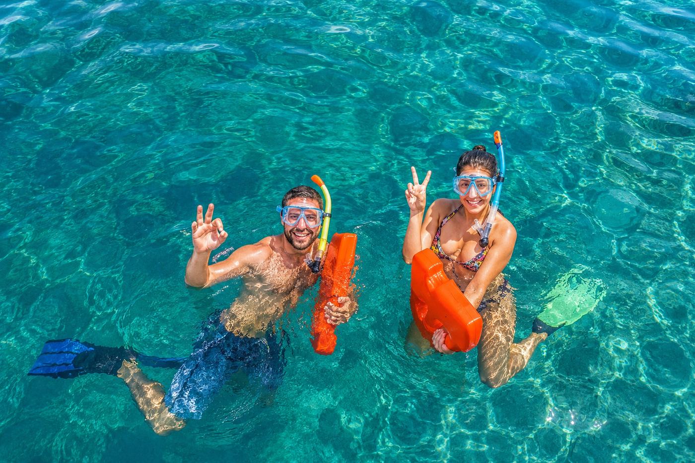 Couple snorkeling in the clear waters of Manuel Antonio